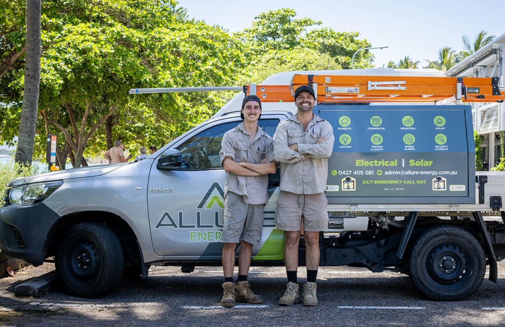 Two top electrical contractors in Cairns standing in front of their service vehicle in Cairns, Queensland.