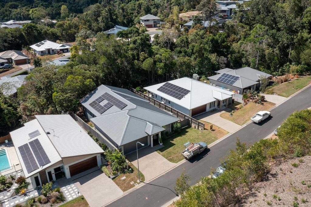 Solar panels installed on multiple residential roofs in Cairns, showcasing Allure Energy's solar solutions.