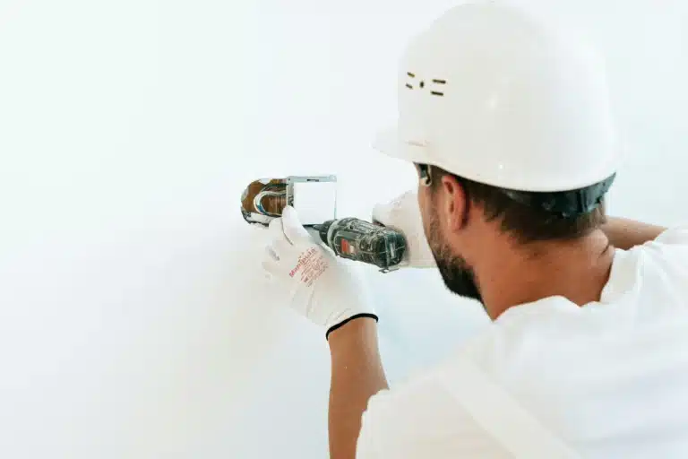 Electrician installing an eco-friendly electrical outlet, representing sustainable energy solutions