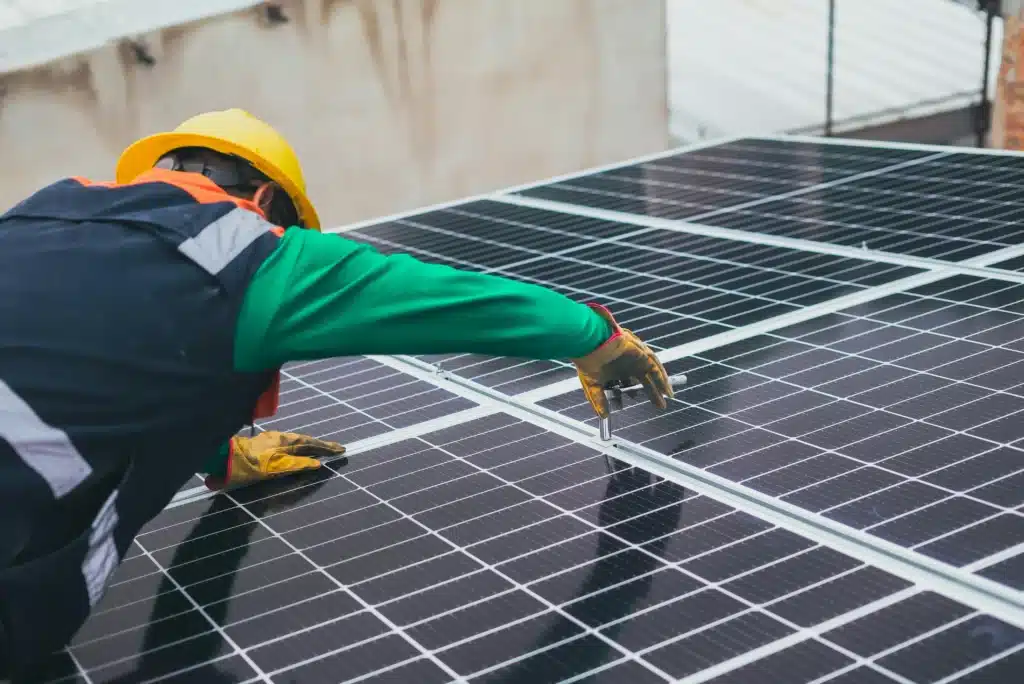 Technician installing solar panels, representing an eco-friendly electrical solution for sustainable energy.