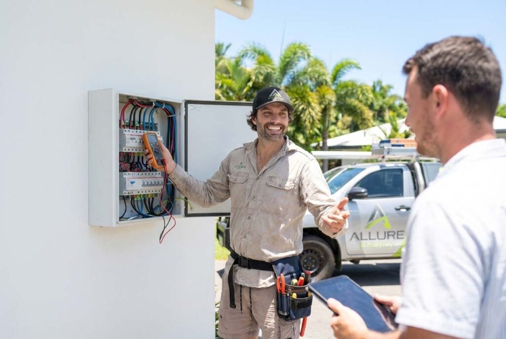 Allure Energy electrician performing a routine outdoor switchboard inspection at a Cairns home, showing transparent pricing and professional service.