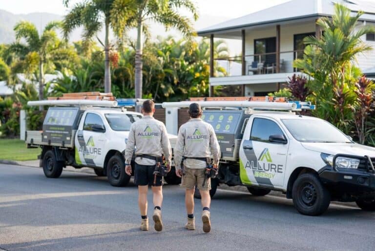Residential electricians in Redlynch walking toward electrical work utes to service a local home