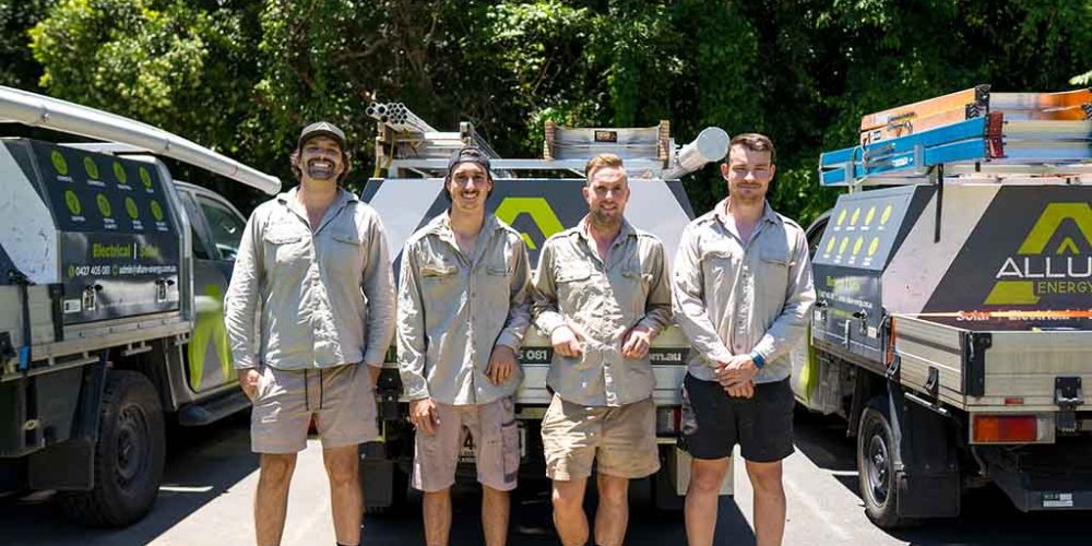 Allure Energy electricians standing in front of service vehicles in Cairns, QLD, ready for electrical and solar installations.